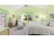 Bright bedroom with vaulted ceiling, ceiling fan, and screened patio access at 187 Sage Cir, Crystal Beach, FL 34681
