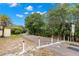 A scenic paved community path shows lush foliage, trees, and a bright blue sky at 187 Sage Cir, Crystal Beach, FL 34681