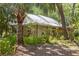 Secluded home surrounded by lush greenery offers a tranquil escape with its charming exterior and inviting ambiance at 187 Sage Cir, Crystal Beach, FL 34681