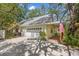 Charming home features a garage, covered porch, and lush landscaping, creating a welcoming curb appeal at 187 Sage Cir, Crystal Beach, FL 34681