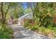 Charming home with mature landscaping, inviting curb appeal, and American flags at 187 Sage Cir, Crystal Beach, FL 34681
