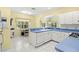Well-lit eat-in kitchen with white appliances, cabinetry, and blue countertops at 187 Sage Cir, Crystal Beach, FL 34681