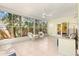 Enclosed sunroom with tile floors, ample natural light, and ceiling fan at 187 Sage Cir, Crystal Beach, FL 34681