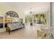 Bright sunroom with wicker seating, tile flooring, and view to the garden at 187 Sage Cir, Crystal Beach, FL 34681