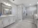 Modern bathroom with a sleek vanity, framed mirror, and a glass-enclosed shower at 19554 Roseate Dr, Lutz, FL 33558