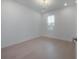 Bright bedroom featuring light hardwood floors, white trim, and a contemporary chandelier for modern elegance at 19554 Roseate Dr, Lutz, FL 33558