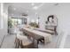 Bright dining room open to the living room and kitchen features a modern table and marble floors at 19554 Roseate Dr, Lutz, FL 33558