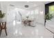 Open-concept dining room features marble floors, staircase, and large windows at 19554 Roseate Dr, Lutz, FL 33558