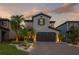 Charming two-story home featuring a brick driveway, well-maintained landscaping, and an attached two-car garage at 19554 Roseate Dr, Lutz, FL 33558