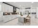 Contemporary kitchen with stainless steel appliances, white cabinets, and a sleek island at 19554 Roseate Dr, Lutz, FL 33558