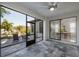 Screened lanai with patio furniture, ceiling fan, and views of the lush backyard and outdoor seating area at 19554 Roseate Dr, Lutz, FL 33558