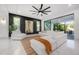 Elegant living room features a modern accent wall, marble floors, and sliding glass doors at 19554 Roseate Dr, Lutz, FL 33558