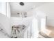 View of the living room from the staircase, featuring high ceilings and modern decor at 19554 Roseate Dr, Lutz, FL 33558