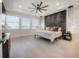 Bright main bedroom with large windows, a dark accent wall, and modern furnishings at 19554 Roseate Dr, Lutz, FL 33558