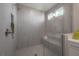 Modern shower with stylish tiles, a built-in seat, and a rainfall shower head at 19554 Roseate Dr, Lutz, FL 33558