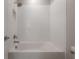Modern bathtub-shower combo with white subway tile, brushed-nickel fixtures, and convenient built-in niche at 19554 Roseate Dr, Lutz, FL 33558