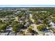 Overhead shot showing houses with mature trees, and a pond in the distance at 1985 Hastings Dr, Clearwater, FL 33763