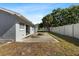 Concrete back patio featuring a fire pit and sliding glass door to the house with a fenced yard at 1985 Hastings Dr, Clearwater, FL 33763