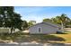 View of the home's backyard, showing the siding, windows and manicured lawn at 1985 Hastings Dr, Clearwater, FL 33763