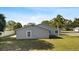 View of the home's backyard, showing the siding, windows and manicured lawn at 1985 Hastings Dr, Clearwater, FL 33763