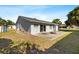 View of backyard with concrete patio and nice green lawn at 1985 Hastings Dr, Clearwater, FL 33763