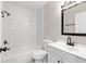 Clean bathroom with white tiled shower, new vanity, and black fixtures at 1985 Hastings Dr, Clearwater, FL 33763