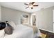 Cozy bedroom featuring a ceiling fan, natural light and ensuite bathroom entrance at 1985 Hastings Dr, Clearwater, FL 33763