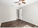 Simple bedroom featuring laminate flooring, a ceiling fan, and white trim at 1985 Hastings Dr, Clearwater, FL 33763