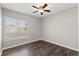 Bare bedroom features hardwood floors, a window, and ceiling fan at 1985 Hastings Dr, Clearwater, FL 33763