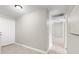 Bright hallway with tile flooring and neutral paint, leading to various rooms at 1985 Hastings Dr, Clearwater, FL 33763
