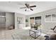 Sunlit living room with tiled flooring, glass patio doors, and minimalist décor at 1985 Hastings Dr, Clearwater, FL 33763