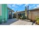 Cozy back deck with table, chairs, and privacy greenery, perfect for outdoor relaxation at 2016 Douglas Ave, Clearwater, FL 33755