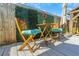 Charming outdoor table and chairs with plush blue cushions on a sunny wood deck at 2016 Douglas Ave, Clearwater, FL 33755