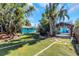 Spacious backyard featuring lush greenery, a pergola, and a well-manicured lawn at 2016 Douglas Ave, Clearwater, FL 33755