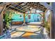 Inviting backyard patio featuring a covered pergola, hot tub, and colorful outdoor rug at 2016 Douglas Ave, Clearwater, FL 33755