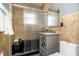Bathroom featuring tiled walls, updated vanity, and a bathtub with shower at 2016 Douglas Ave, Clearwater, FL 33755