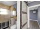 Modern bathroom with tiled shower, updated vanity, and a sliding barn door at 2016 Douglas Ave, Clearwater, FL 33755