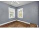 Empty bedroom showcasing hardwood floors and natural light through the windows at 2016 Douglas Ave, Clearwater, FL 33755