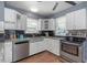 Charming kitchen featuring stainless steel appliances, white cabinets, and stylish countertops at 2016 Douglas Ave, Clearwater, FL 33755