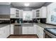 Bright kitchen with modern appliances, white cabinetry, a stainless steel sink, and wood-look floors at 2016 Douglas Ave, Clearwater, FL 33755