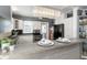 Bright kitchen featuring white cabinets, stainless steel appliances, and a unique, modern light fixture above the countertop at 2016 Douglas Ave, Clearwater, FL 33755