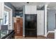 This kitchen features modern white cabinets, a stainless steel refrigerator, and an open pantry at 2016 Douglas Ave, Clearwater, FL 33755