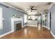 Bright living room featuring hardwood floors, a decorative fireplace, and open access to the kitchen at 2016 Douglas Ave, Clearwater, FL 33755
