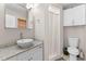 Bright bathroom with pedestal sink, granite countertop, full bath and white vanity at 212 28Th S St, St Petersburg, FL 33712