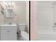 Bathroom with vanity, shower, toilet, pink accessories and bright lighting at 212 28Th S St, St Petersburg, FL 33712