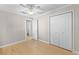 Bedroom with ceiling fan, hardwood floors, double door closet and hall access at 212 28Th S St, St Petersburg, FL 33712