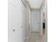 Hallway features neutral paint, tiled flooring, multiple closets and doorways to rooms at 212 28Th S St, St Petersburg, FL 33712