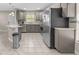 Modern kitchen with gray cabinets, stainless steel appliances, and tile backsplash at 212 28Th S St, St Petersburg, FL 33712