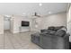 Comfortable living area with tile flooring, TV and large sectional couch at 212 28Th S St, St Petersburg, FL 33712