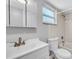 Bright bathroom features a vanity with storage, framed mirror, and a toilet with tub and shower at 2122 Bradford St # 505, Clearwater, FL 33760